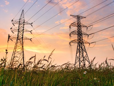 Silhouette of high voltage power lines at sunrise